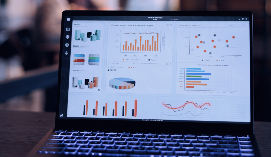 A laptop screen displaying colorful charts and graphs for profits, cash flow, and projections in a business administration dashboard.