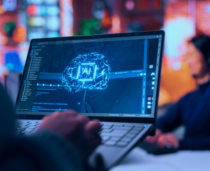 A person holds a laptop displaying a vibrant, digital representation of a brain with circuitry, symbolizing artificial intelligence development.