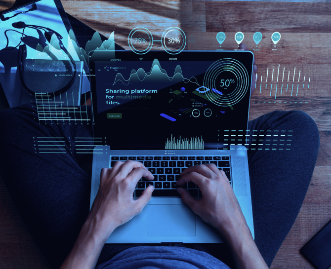 Person using a laptop on a wooden surface, featuring a multimedia sharing platform interface with various data visualizations.