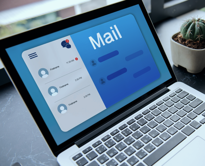 Open laptop displaying an email interface with unread messages notification. A small cactus is visible on the desk, adding a touch of greenery.
