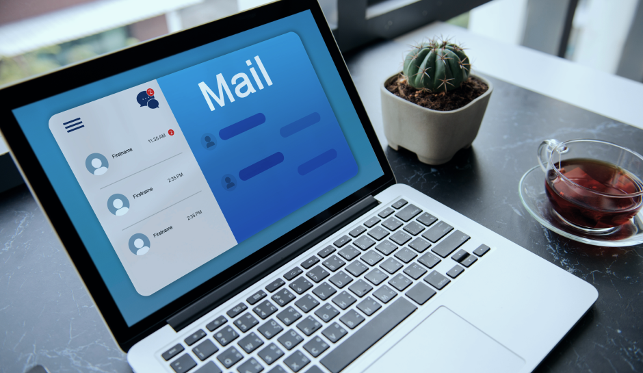 Open laptop displaying an email interface with unread messages notification. A small cactus is visible on the desk, adding a touch of greenery.