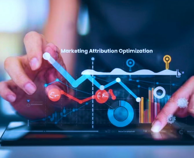 Hands interacting with a tablet displaying marketing attribution optimization charts, graphs, and data visualizations.