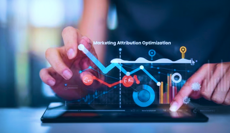 Hands interacting with a tablet displaying marketing attribution optimization charts, graphs, and data visualizations.